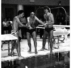 Dave and Rob Town assist their father Fred in being the “Official First Person” into the new pool.