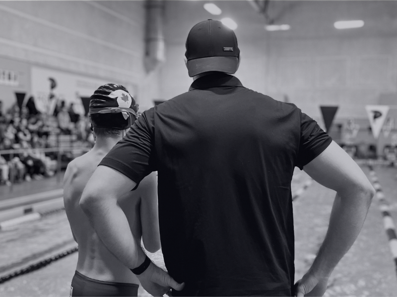 Coach working with a swimmer during warm up