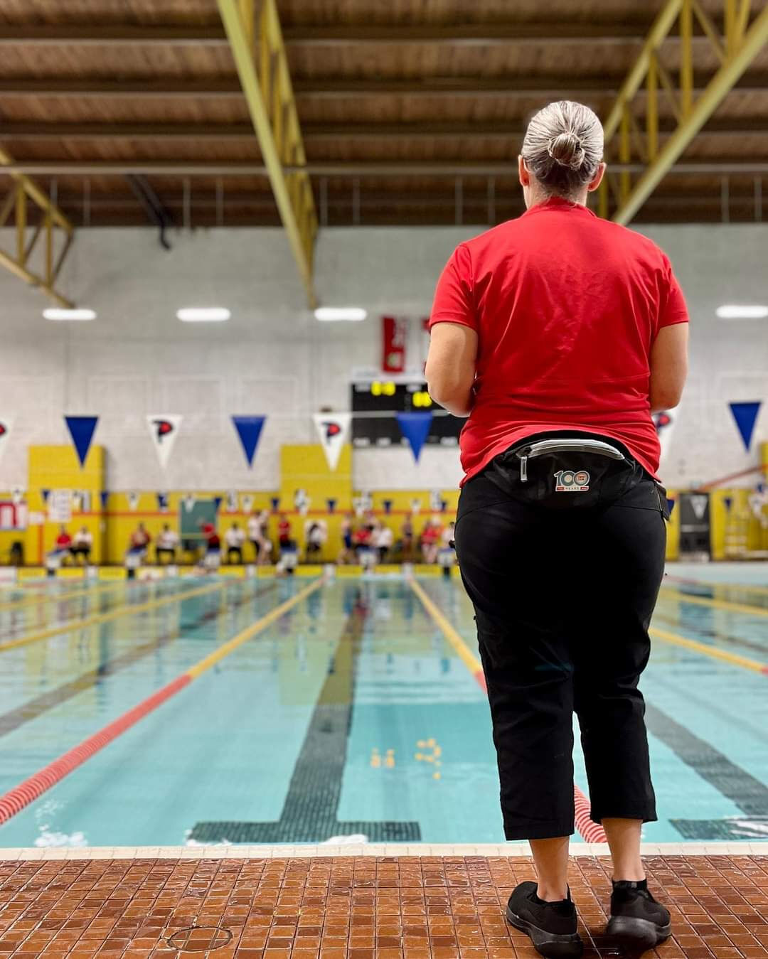 A Pickering Swim Club official monitoring a swim meet from the pool deck