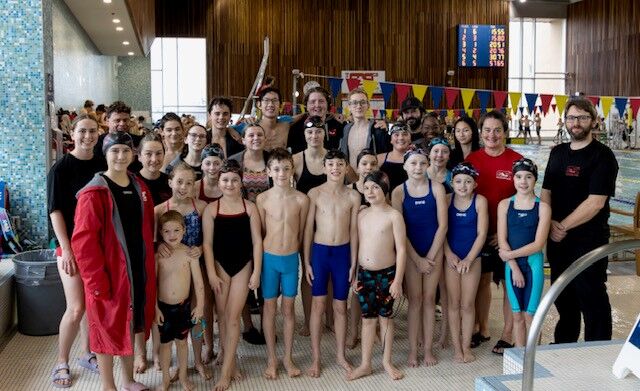 Group of some SDSC swimmers gathered on deck before a swim meet.