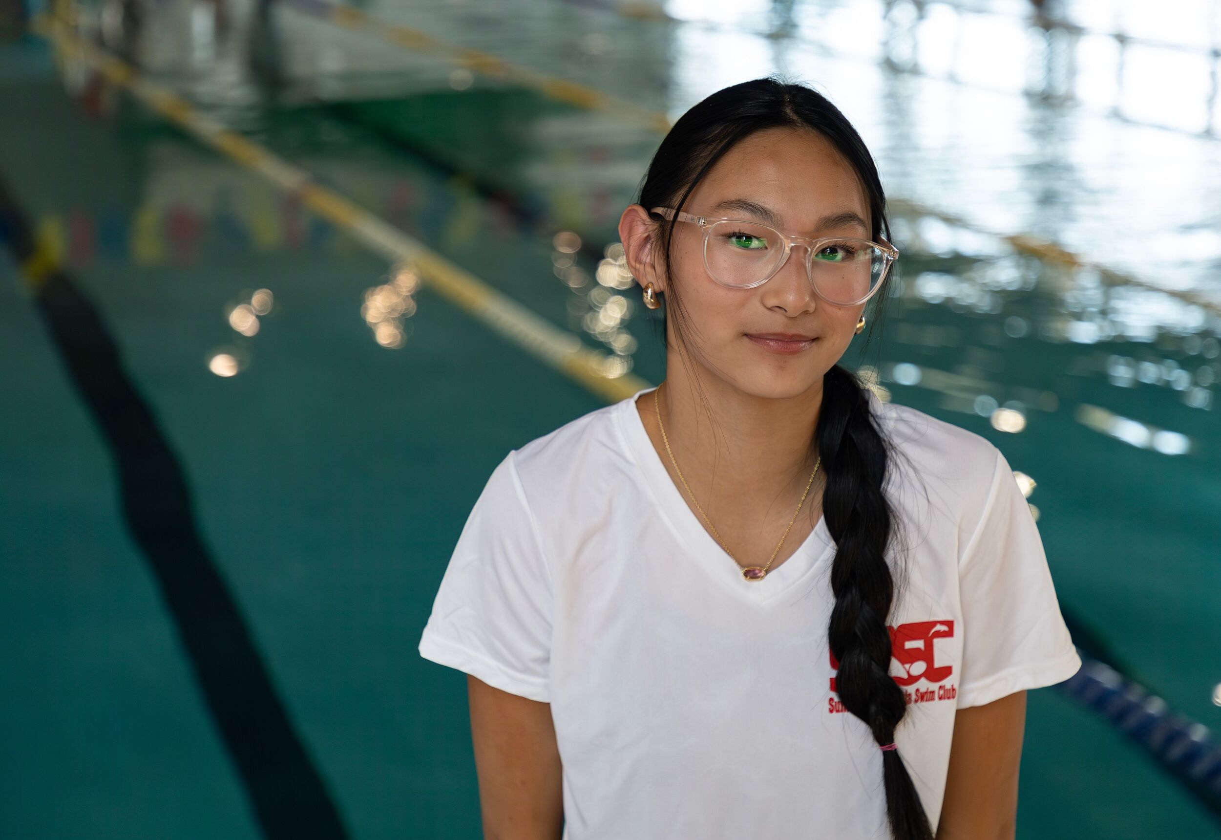 Headshot of Tya Brant, Assistant Coach with pool in background