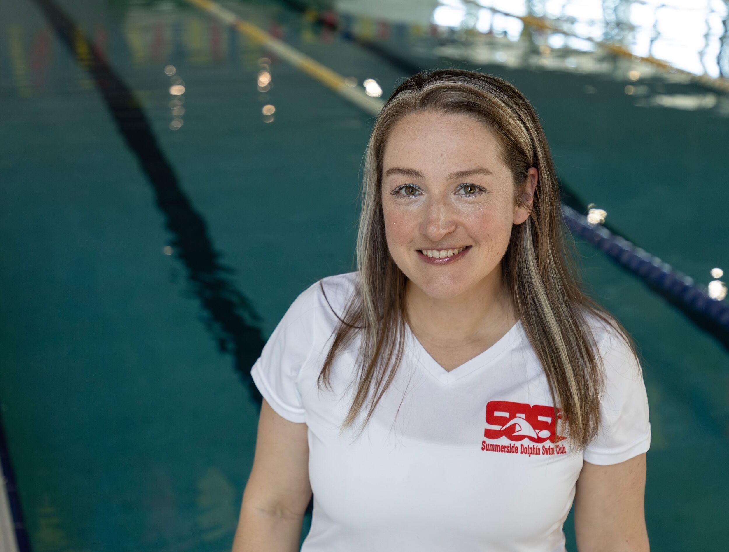 Headshot of Jill LeBlanc, Assistant Coach with pool in background