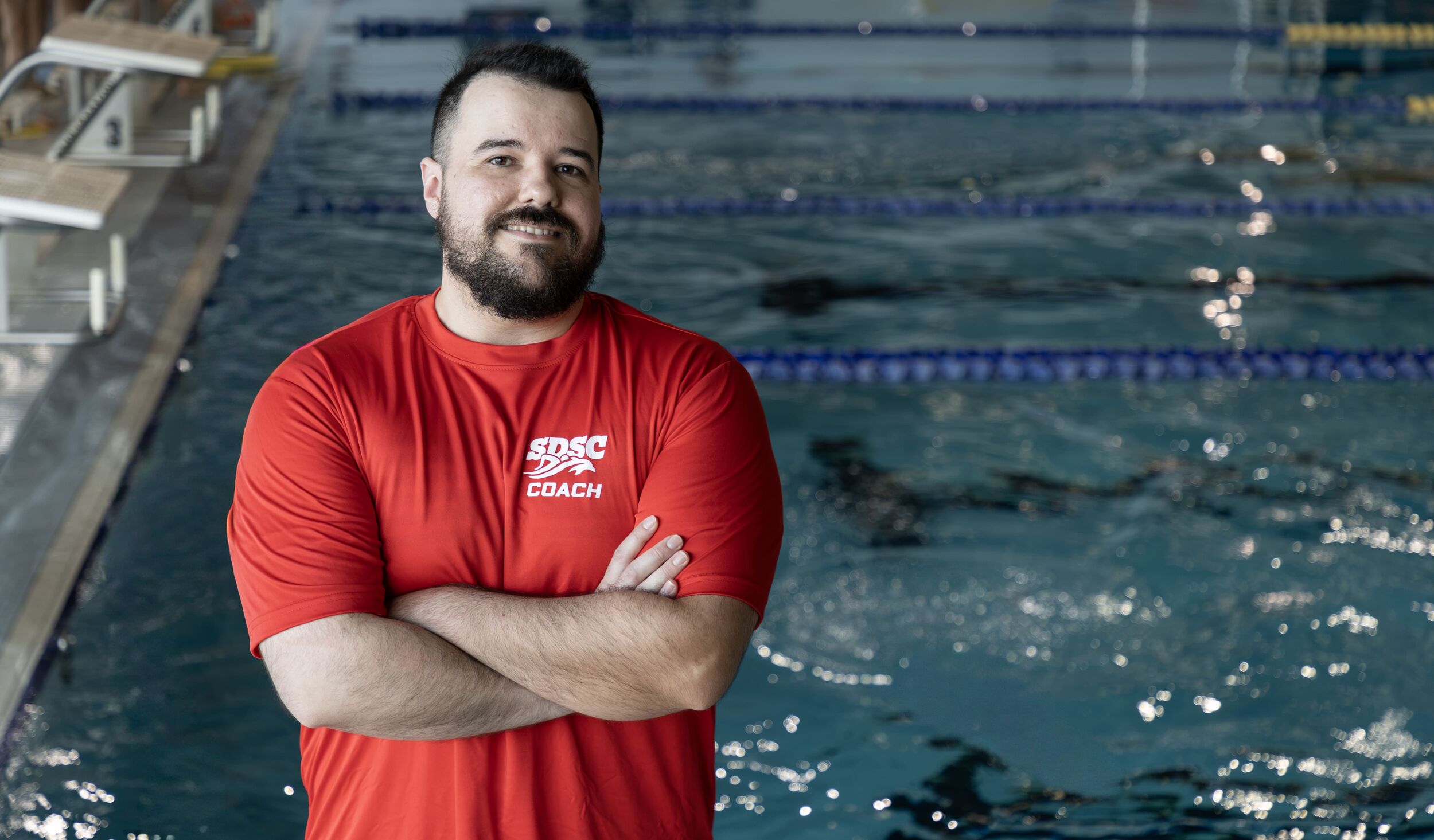 Headshot of Zach Martin, Assistant Coach with pool in background