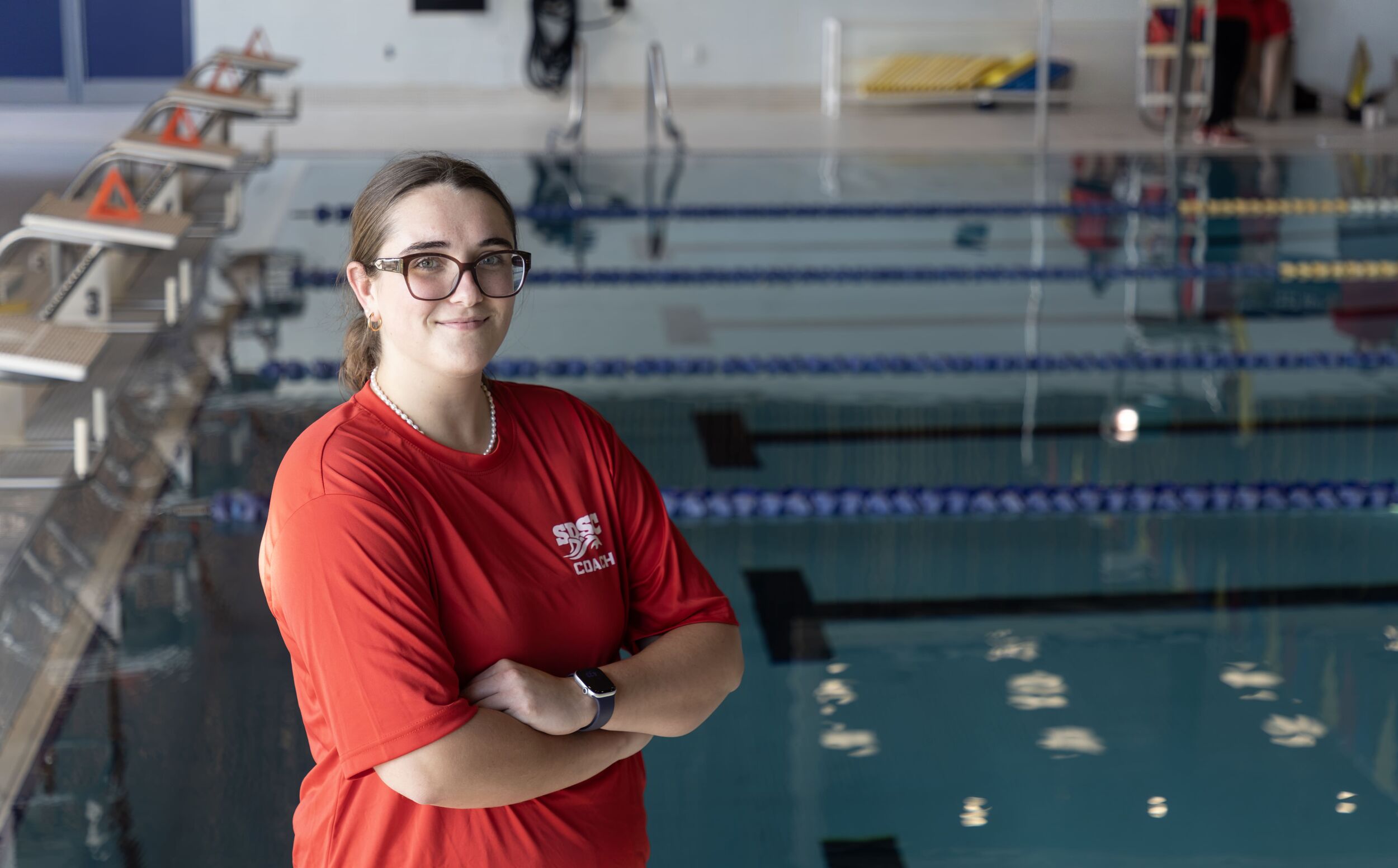 Headshot of Jill LeBlanc, Assistant Coach with pool in background