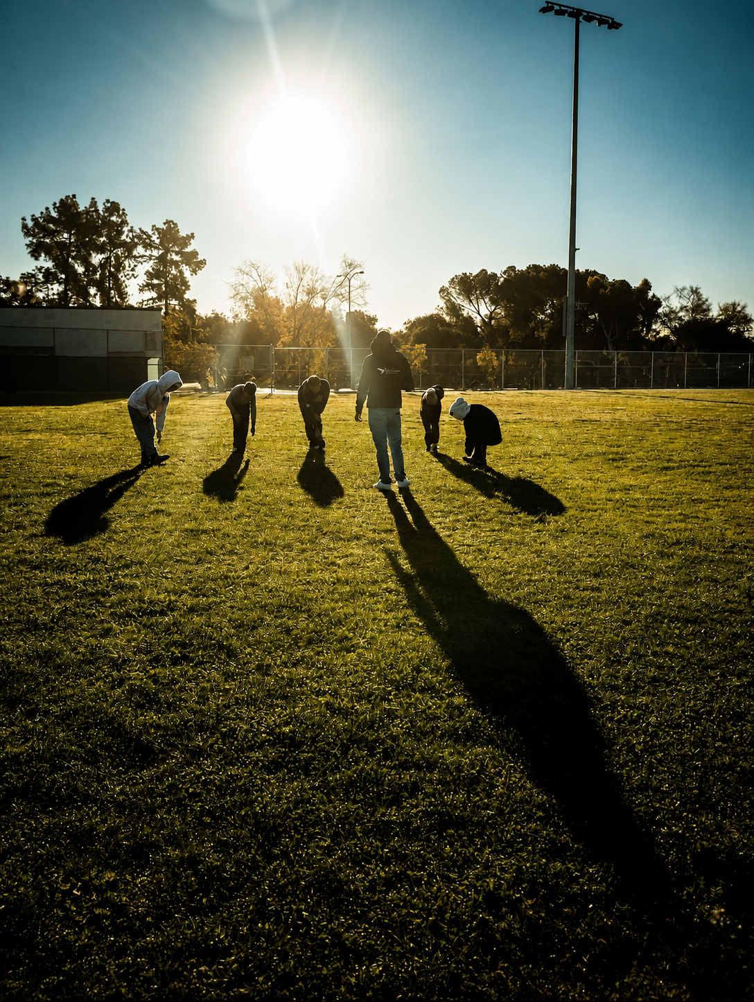 Swimmers dryland dynamic warmup on a grassy field