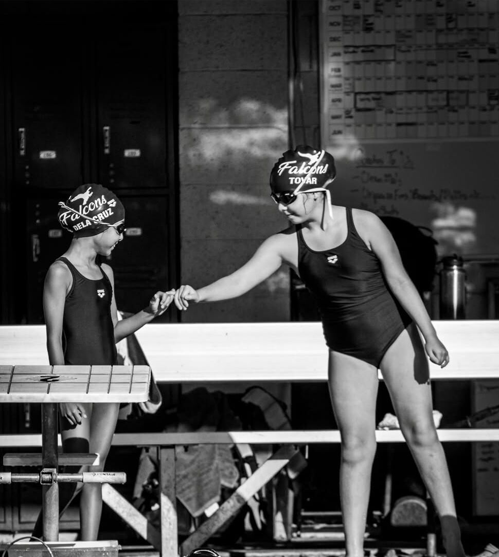 Falcons swimmers fist bumping