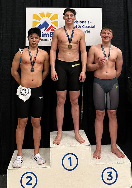 Winskill Dolphins swimmers receiving medals