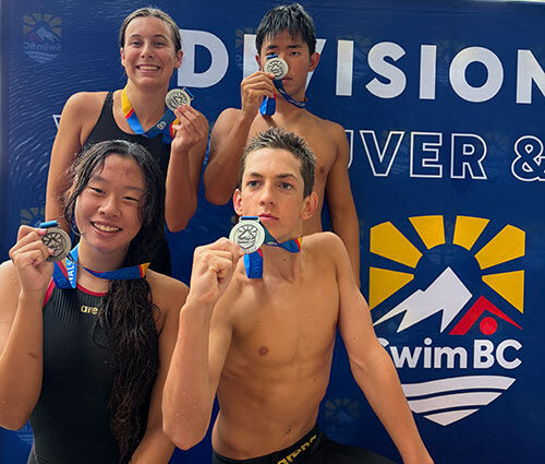Winskill Dolphins swimmers receiving medals