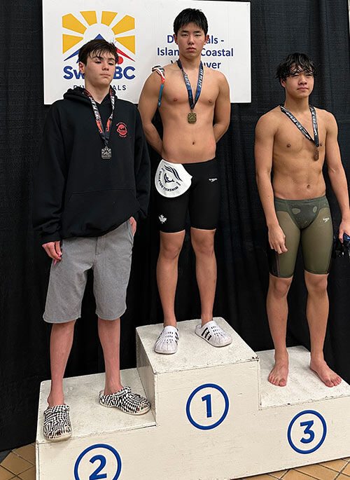 Winskill Dolphins swimmers receiving medals