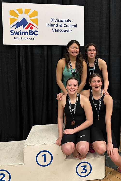 Winskill Dolphins swimmers receiving medals